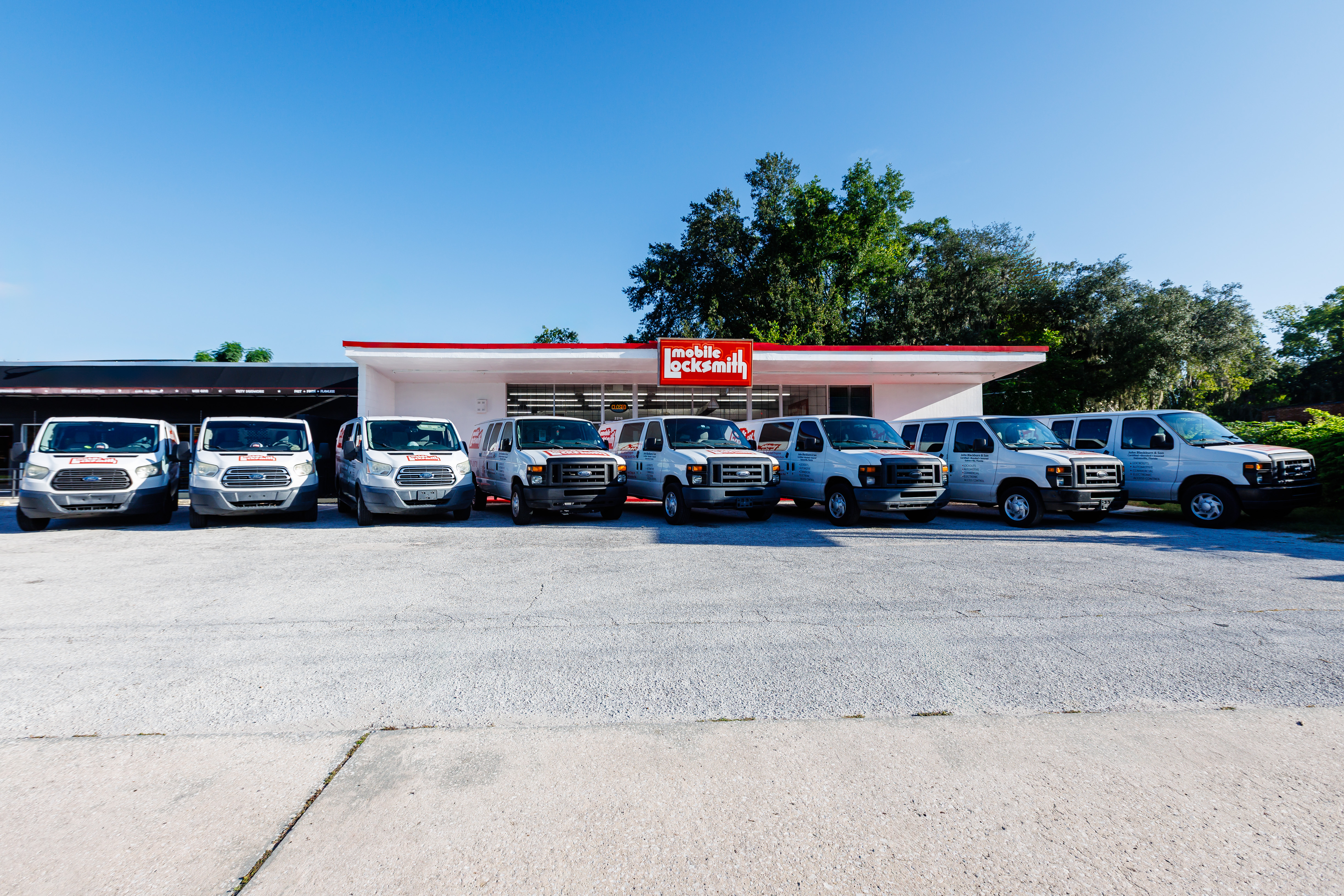 Mobile Locksmith Van Fleet — Gainesville, FL Mobile Locksmith service van fleet parked in front of the Gainesville storefront